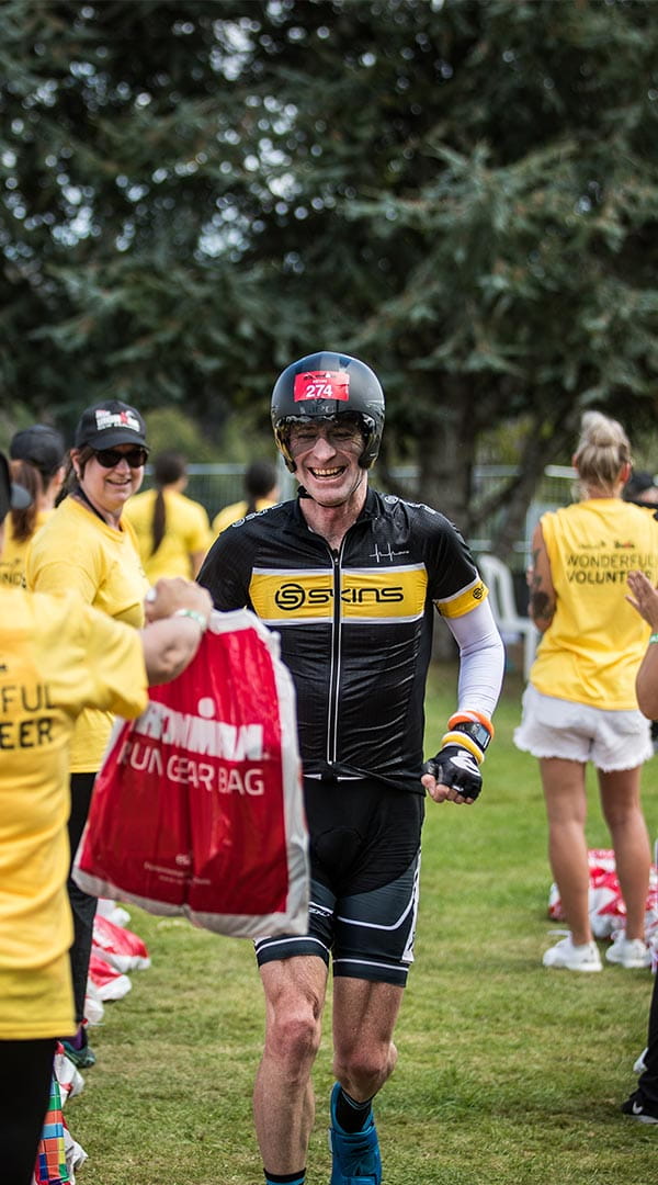 Mercury volunteers cheering on Ironman athlete at transition