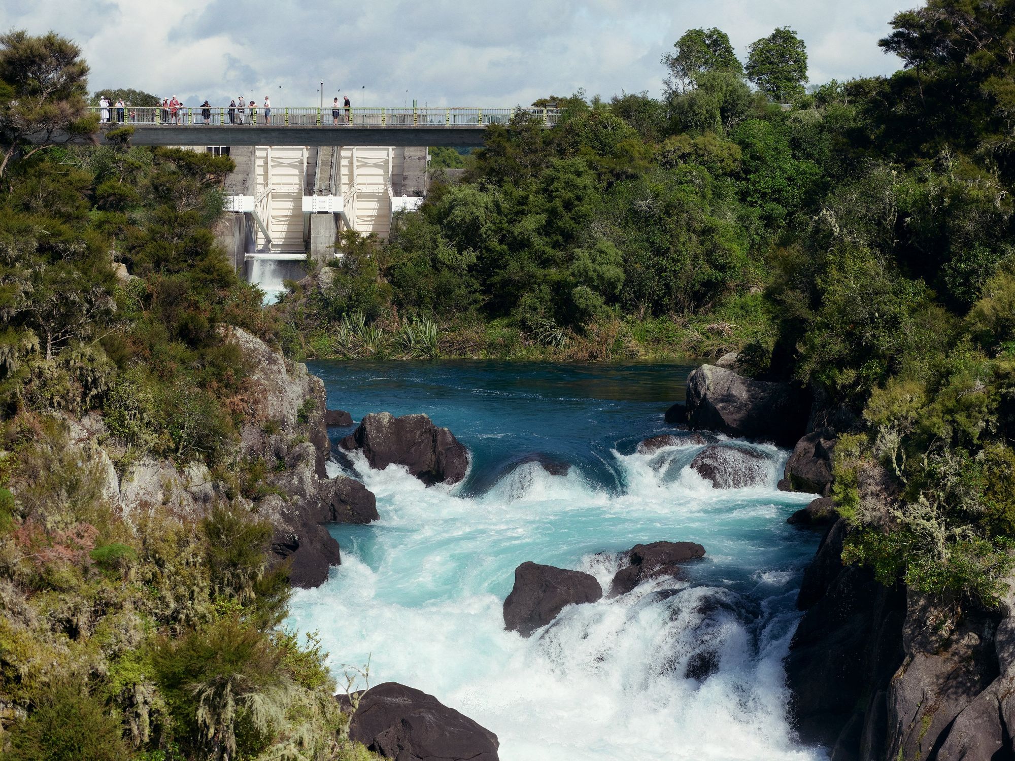 image of water flowing through Aratiatia rapids with spillway in background