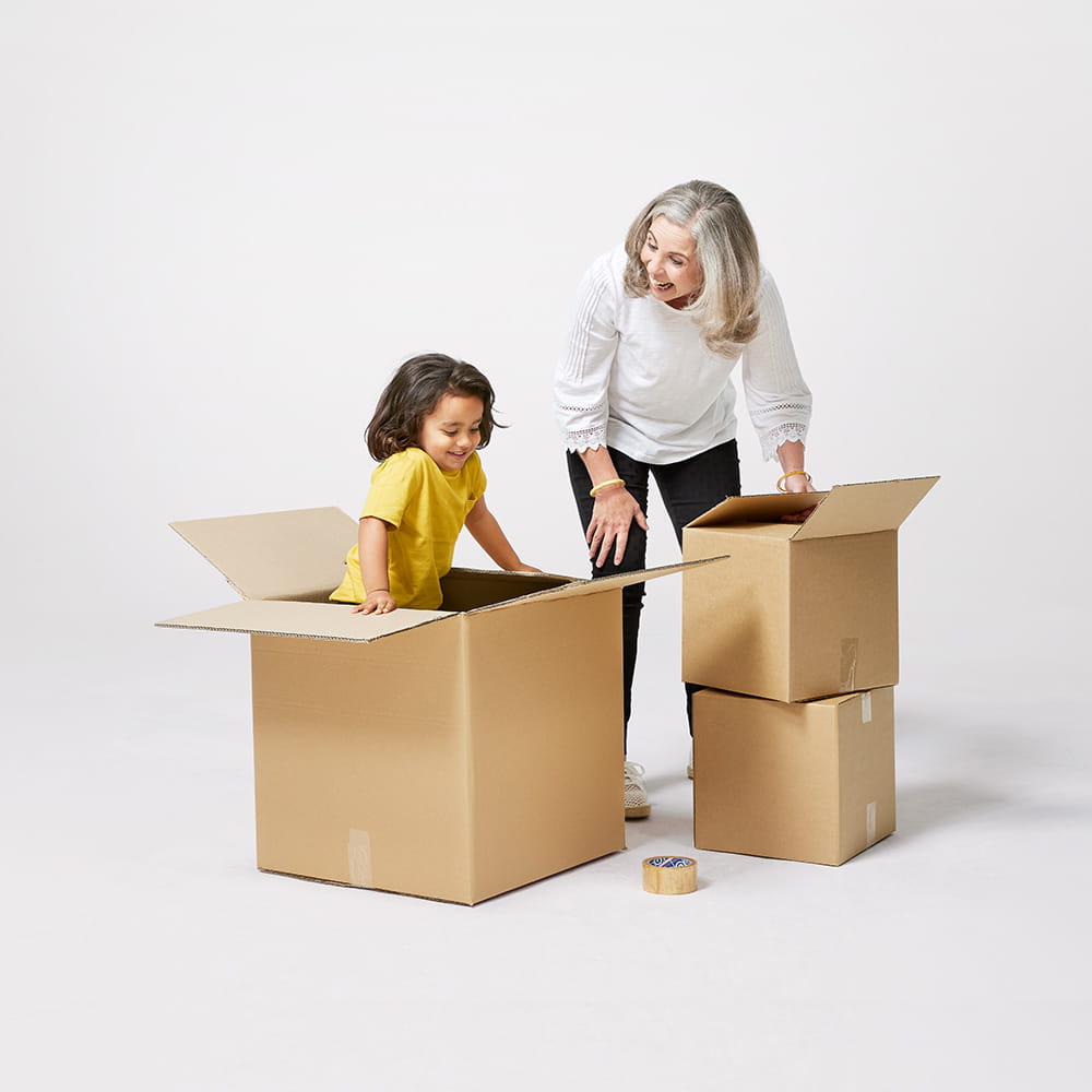 Grandmother and grandchild playing while packing