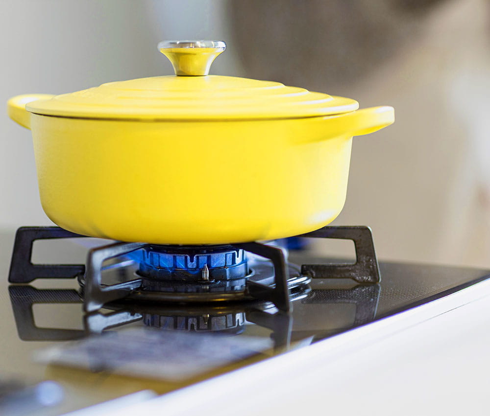 Yellow pot on a gas stove.
