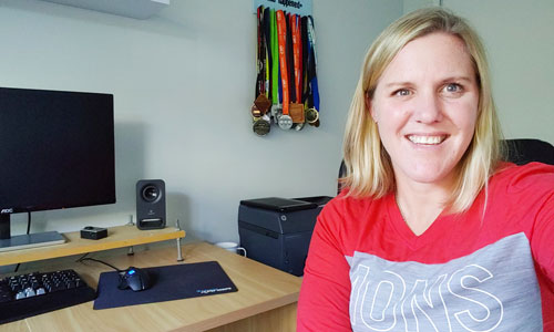 Women sitting at home office desk and smiling.