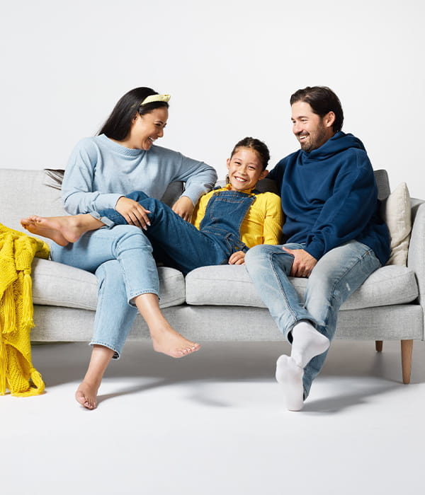 Happy family sitting on sofa