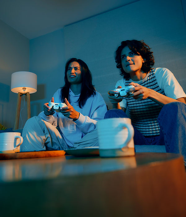 Mother and son playing video games late at night.